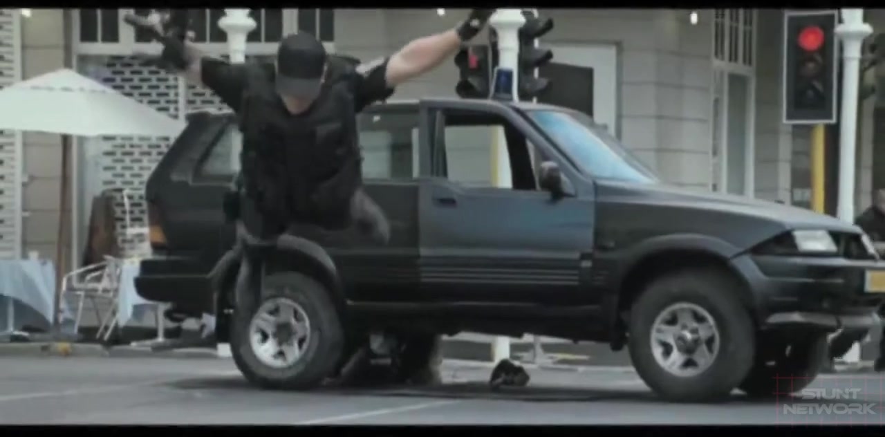 Stunt performer over moving vehicle